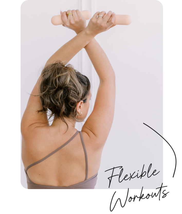 Back of a woman holding bala weights during her workout class.