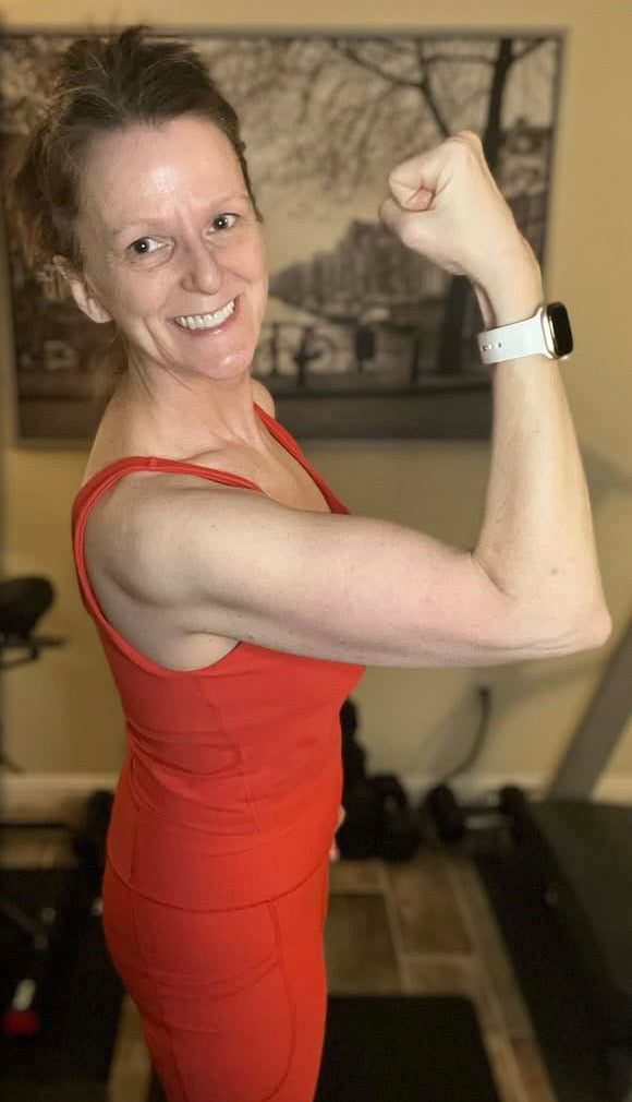 Woman flexing and being proud of her progress in fitness.