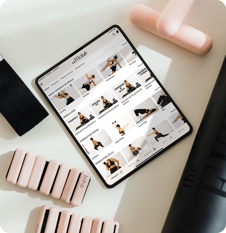 Bala weights, bala ankle weights and an Ipad with The FITclub app displayed.